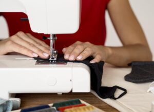 front-view-woman-sewing-face-mask-with-thread