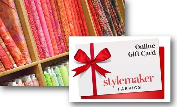 Bolts of printed fabric and Style Maker Fabrics gift card